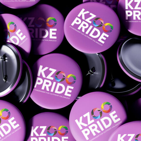 Kalamazoo Pride logo displayed on pile of buttons.